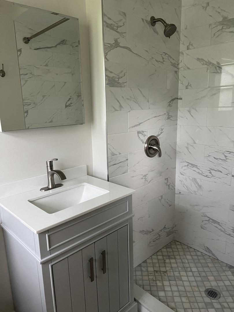 1106 Waukegan Road Deerfield, IL 60015 - Photo 15 of 29 a bathroom with a sink a toilet and shower