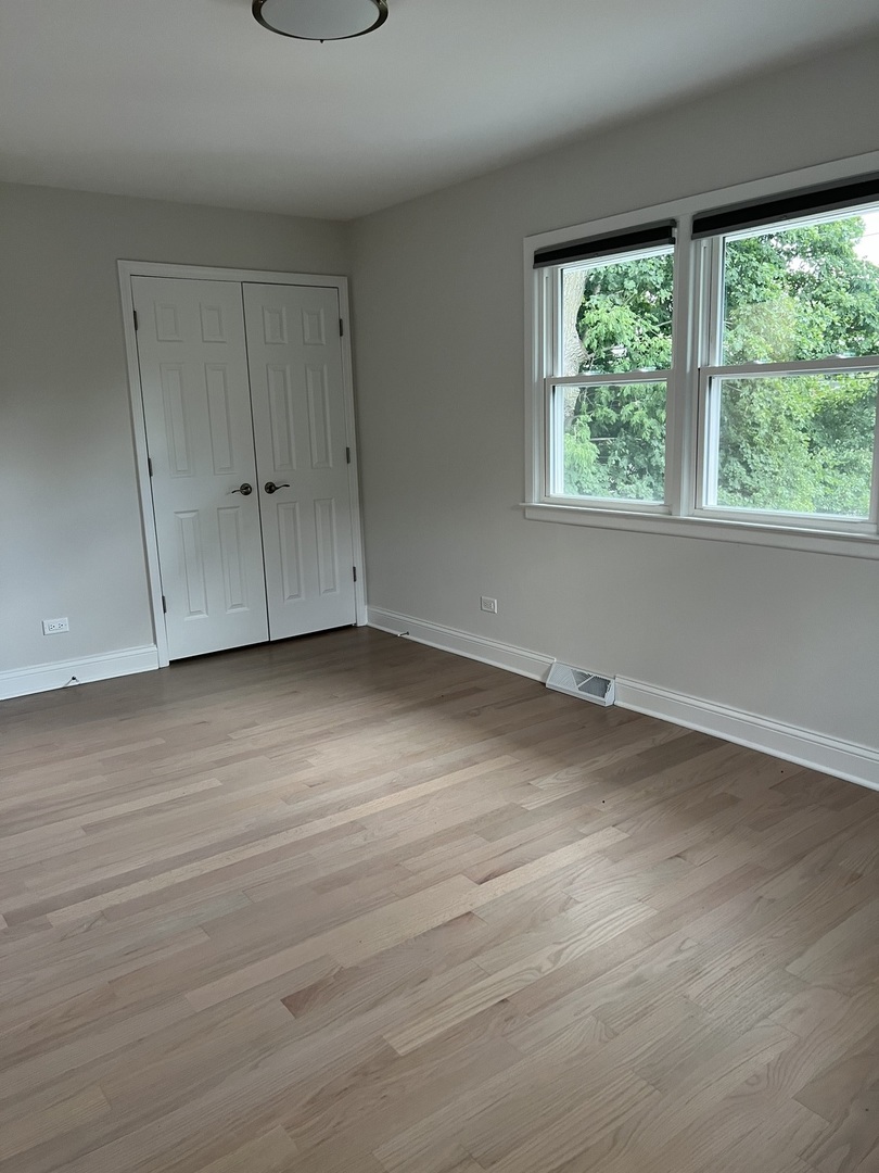 1106 Waukegan Road Deerfield, IL 60015 - Photo 16 of 29 an empty room with wooden floor and windows
