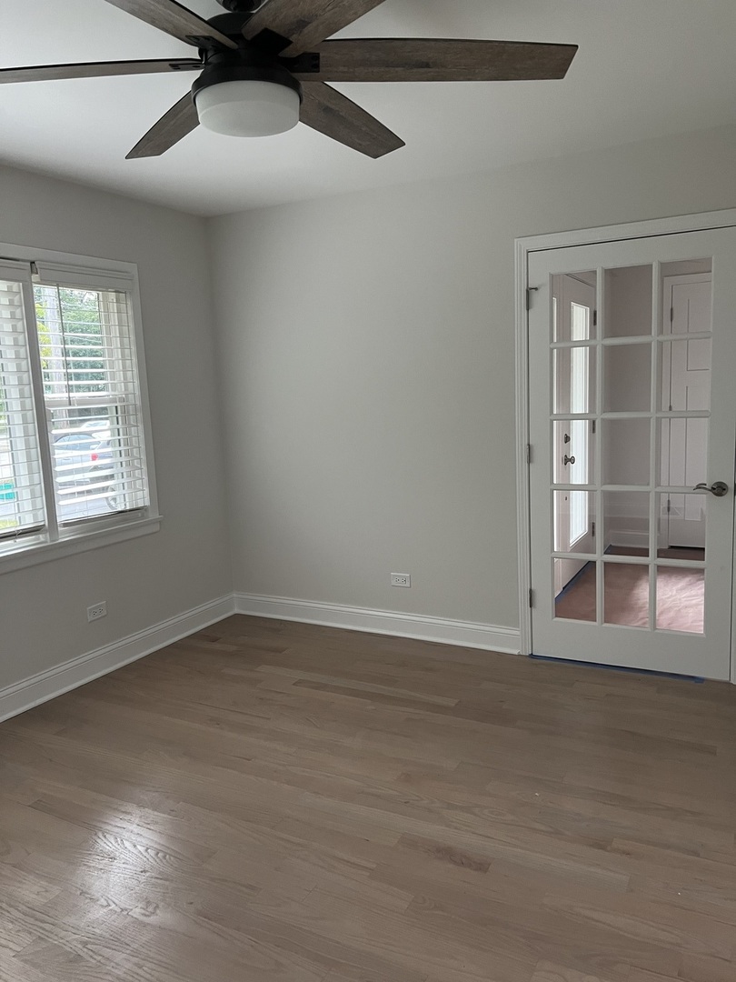 1106 Waukegan Road Deerfield, IL 60015 - Photo 7 of 29 a view of an empty room with wooden floor and a window