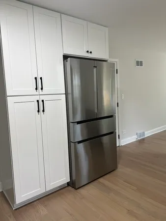 a kitchen with stainless steel appliances a refrigerator and cabinets