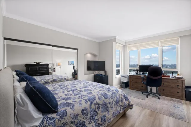 a bedroom with a bed and a flat screen tv