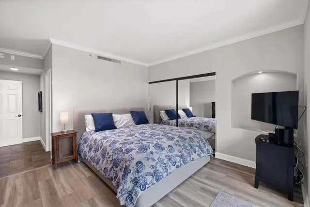 a bedroom with a bed and a flat screen tv