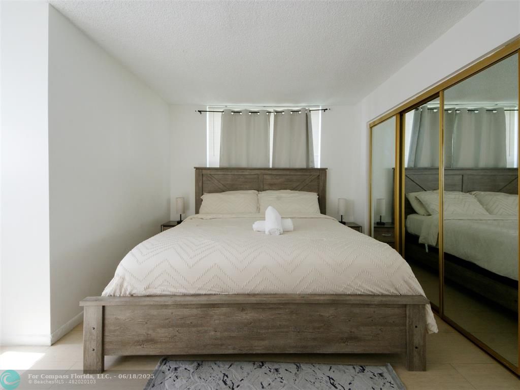 1920 North Congress Avenue, Unit 105 West Palm Beach, FL 33401 - Photo 14 of 19 a bedroom with a bed and a window