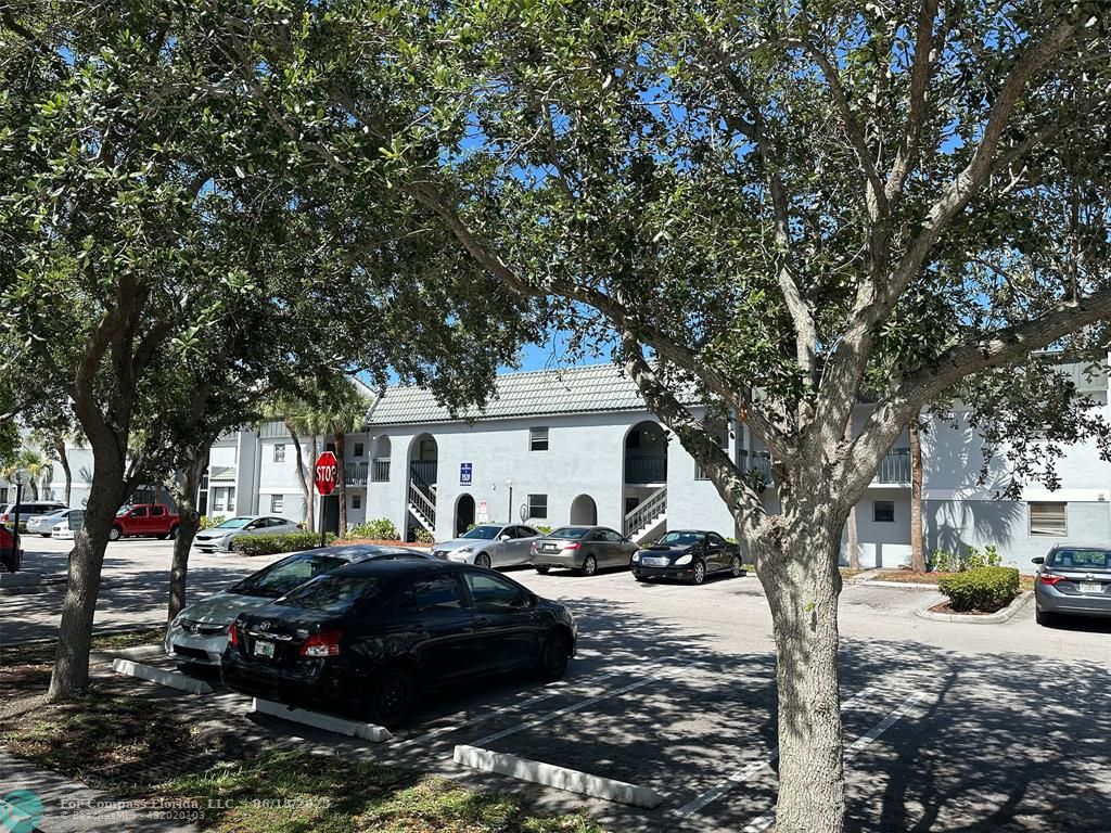 1920 North Congress Avenue, Unit 105 West Palm Beach, FL 33401 - Photo 16 of 19 a car parked in front of white house