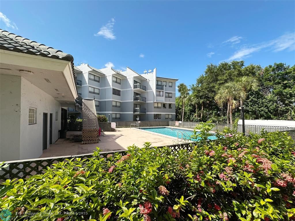 1920 North Congress Avenue, Unit 105 West Palm Beach, FL 33401 - Photo 18 of 19 a view of a swimming pool with an outdoor space and seating area