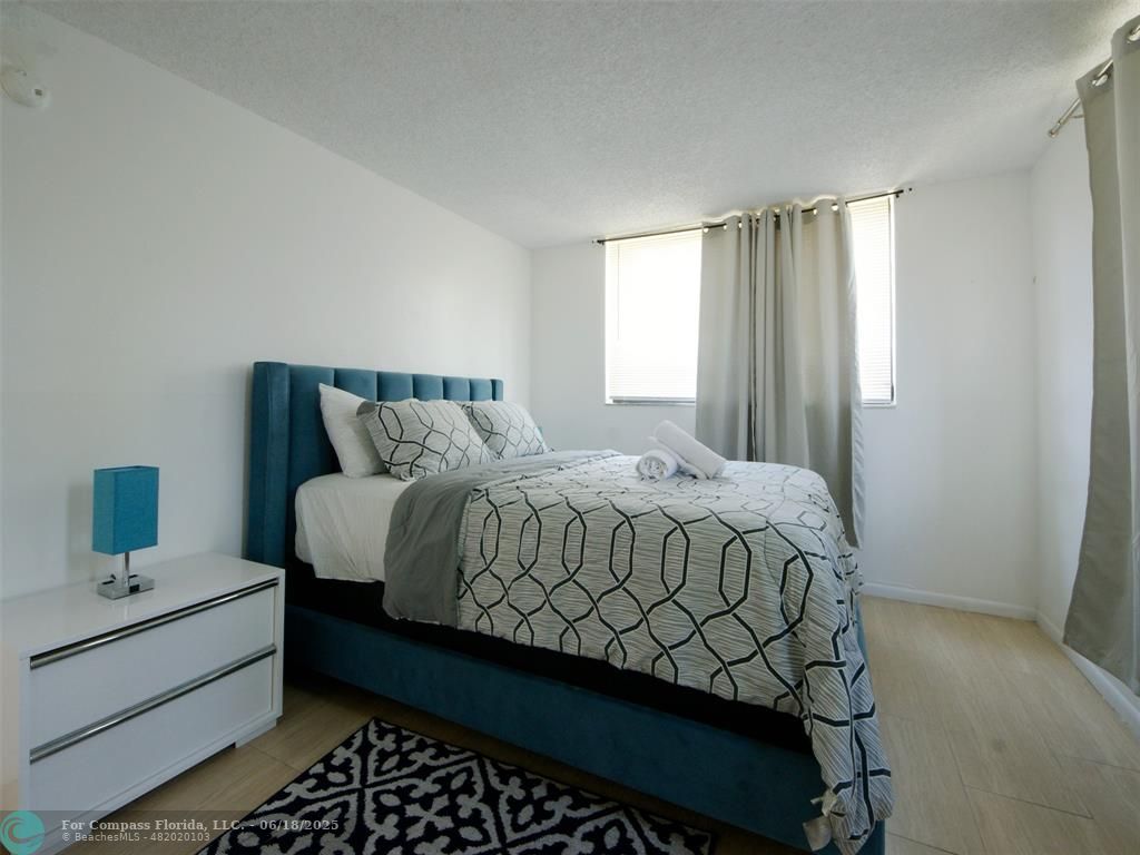 1920 North Congress Avenue, Unit 105 West Palm Beach, FL 33401 - Photo 7 of 19 a bedroom with a bed and window