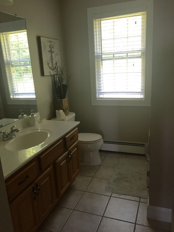 3 Eastern Lane Rutland, MA 01543 - Photo 15 of 22 a bathroom with a granite countertop toilet a sink a mirror and a window