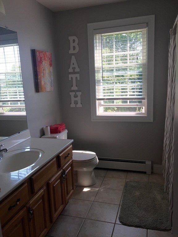 3 Eastern Lane Rutland, MA 01543 - Photo 18 of 22 a bathroom with a granite countertop sink a toilet and a window