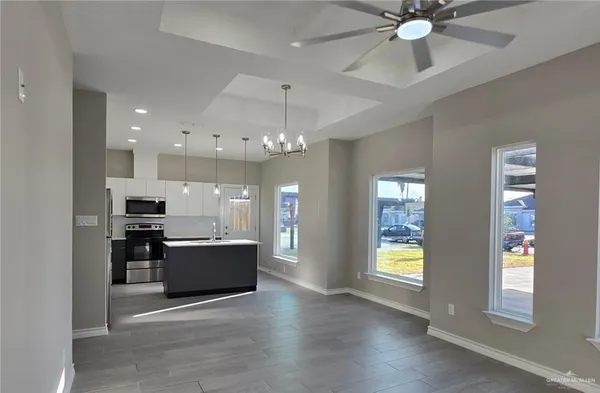 a view of kitchen and window with a ceiling fan