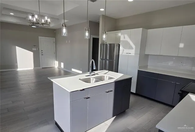 a kitchen with a sink and chandelier