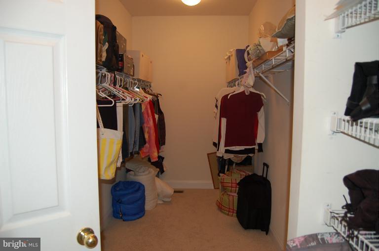 8312 Banister Road Severn, MD 21144 - Photo 19 of 21 a view of walk in closet with clothes