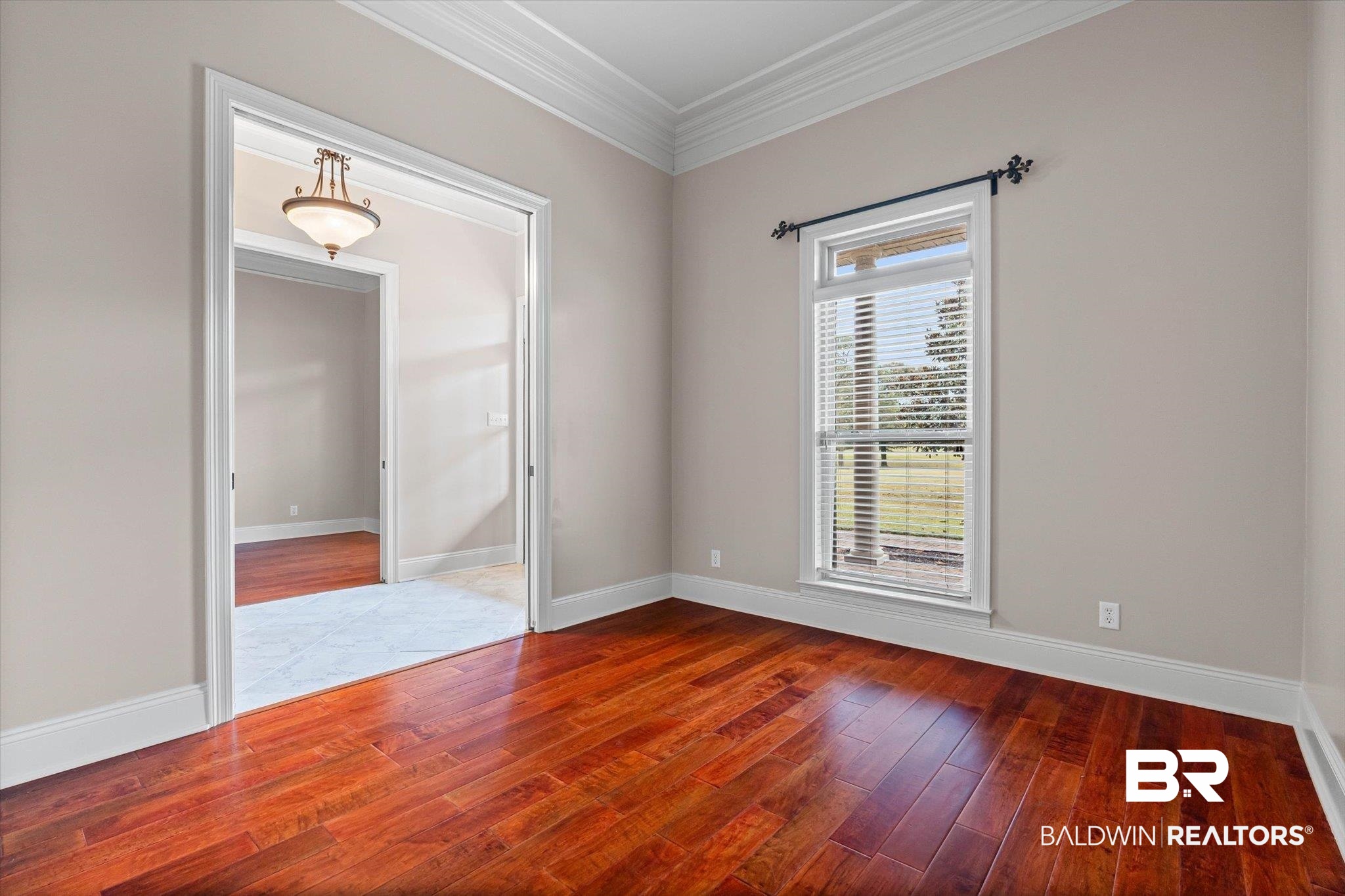 5270 Rodgers Road Eight Mile, AL 36613 - Photo 5 of 38 Empty room with hardwood / wood-style flooring and crown molding