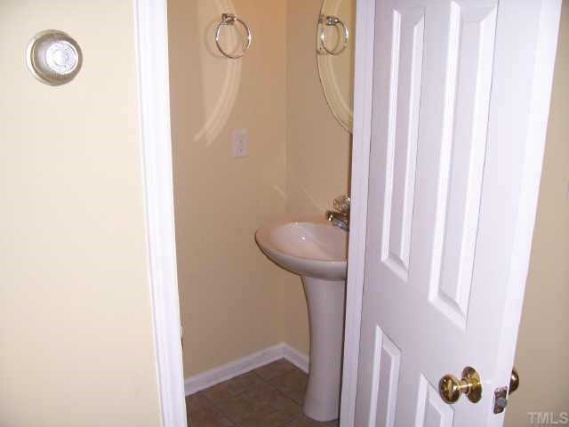 2221 Violet Court Raleigh, NC 27610 - Photo 4 of 9 Brand new ceramic tile in downstairs half bath