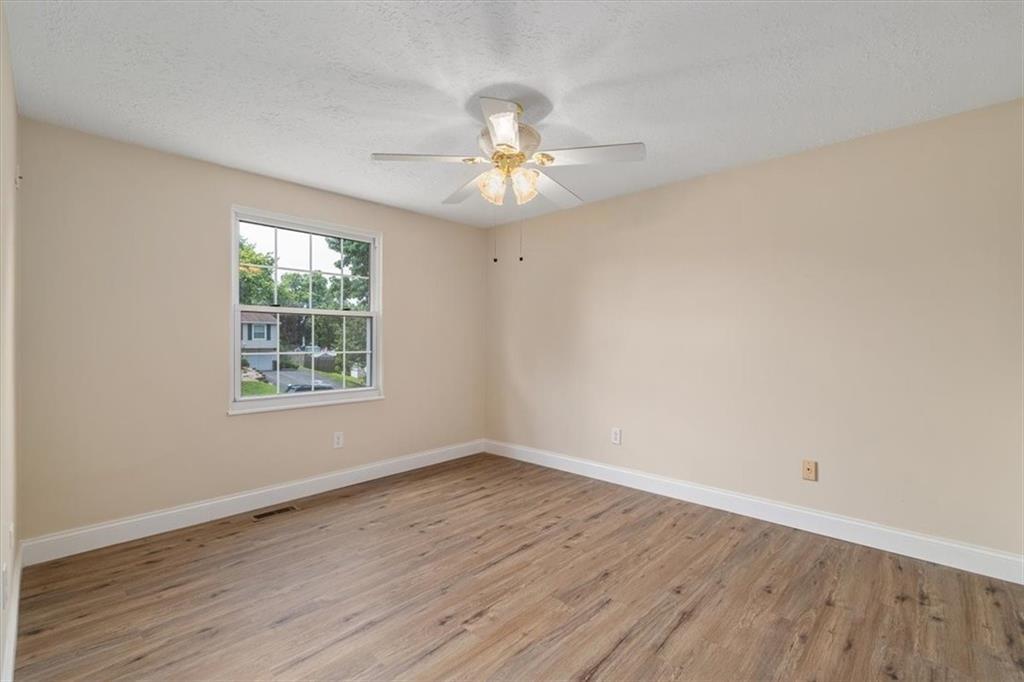 60 Greenleaf Drive Cheswick, PA 15024 - Photo 16 of 29 an empty room with wooden floor chandelier fan and windows