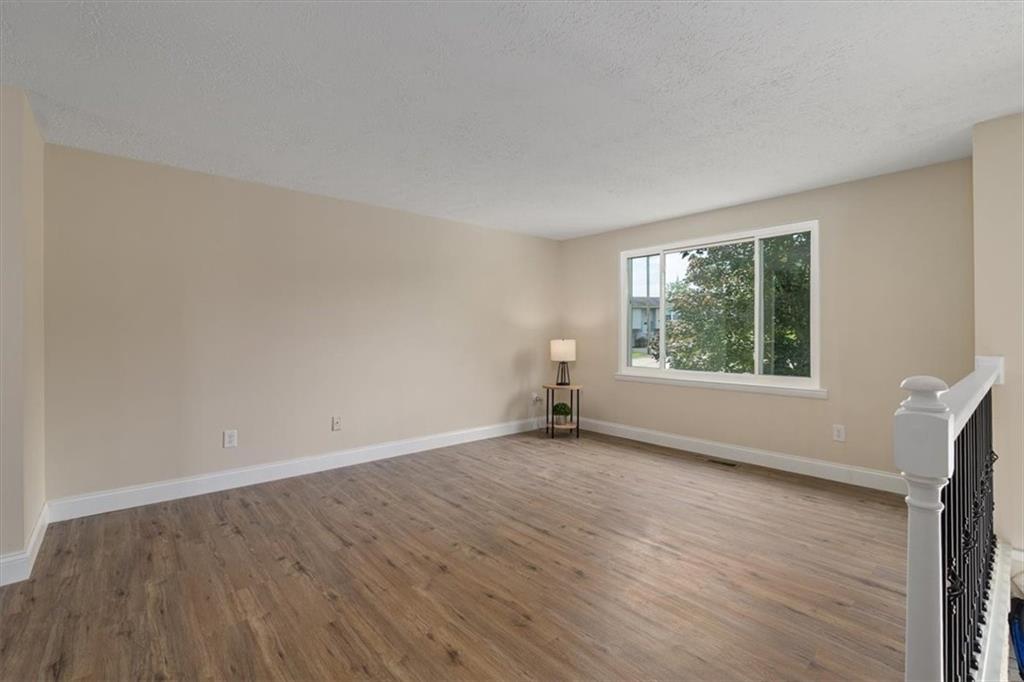 60 Greenleaf Drive Cheswick, PA 15024 - Photo 8 of 29 an empty room with wooden floor and windows
