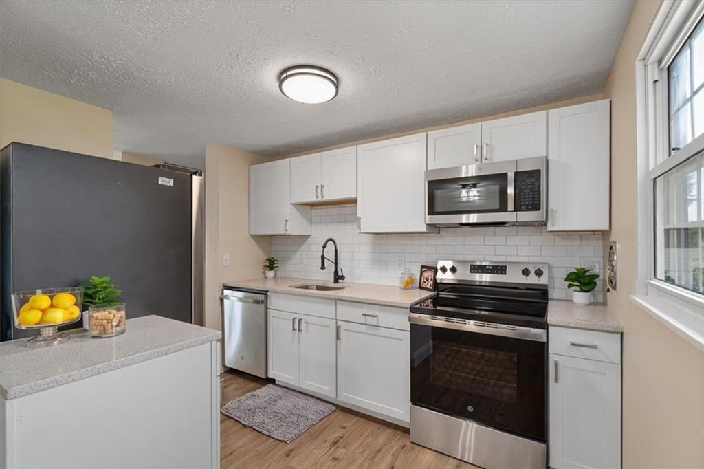 60 Greenleaf Drive Cheswick, PA 15024 - Photo 10 of 29 a kitchen with stainless steel appliances granite countertop a sink a stove oven a counter top space and cabinets