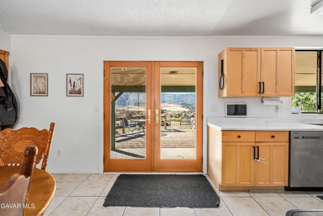 a kitchen with stainless steel appliances granite countertop a refrigerator stove and sink