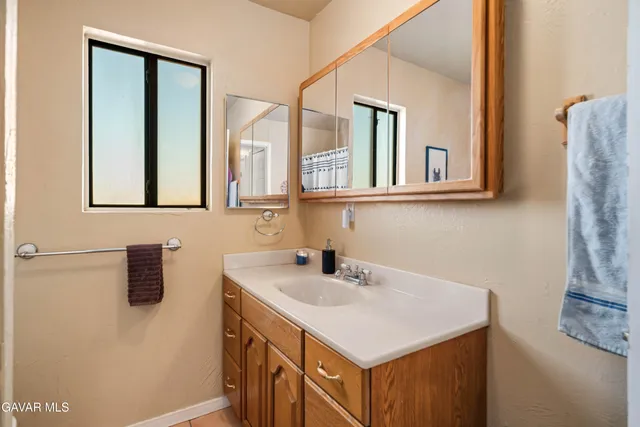 a view of a balcony with wooden floor and seating space
