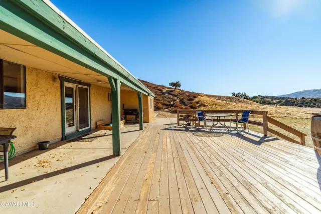 a view of a balcony with wooden floor and city view