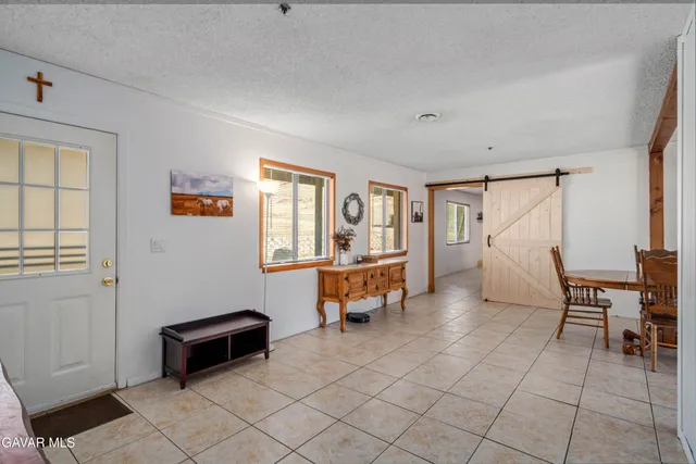 a dining room with furniture and a potted plant