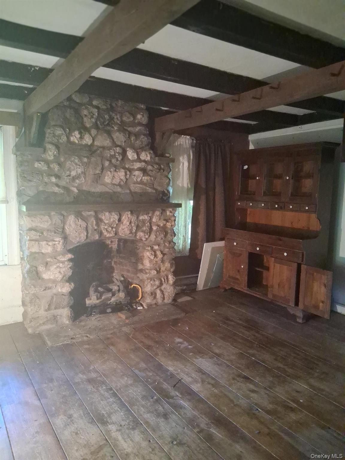84 N Road Red Hook, NY 12571 - Photo 3 of 22 Unfurnished living room with beam ceiling and dark wood-type flooring