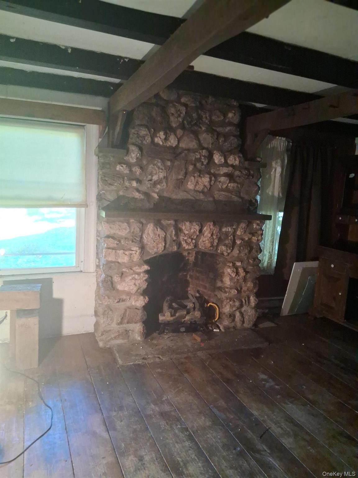 84 N Road Red Hook, NY 12571 - Photo 4 of 22 Living room featuring dark wood finished floors and beam ceiling