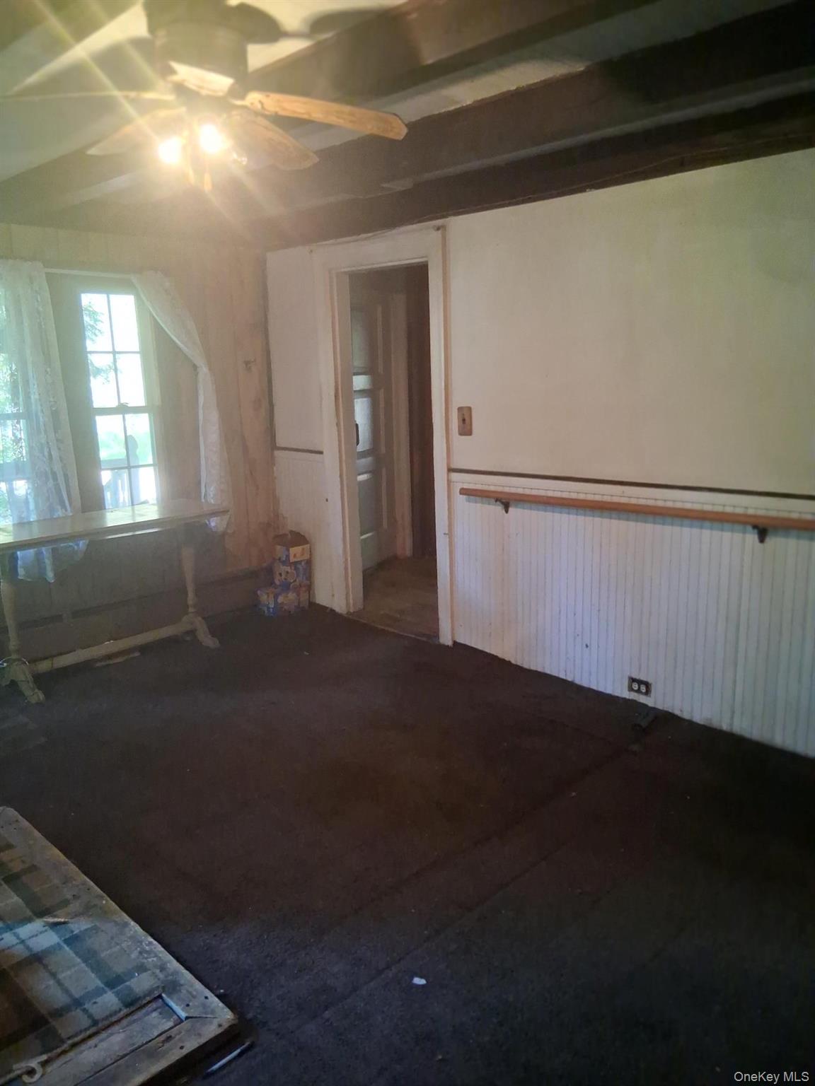 84 N Road Red Hook, NY 12571 - Photo 5 of 22 Spare room featuring a ceiling fan, wainscoting, and wood walls