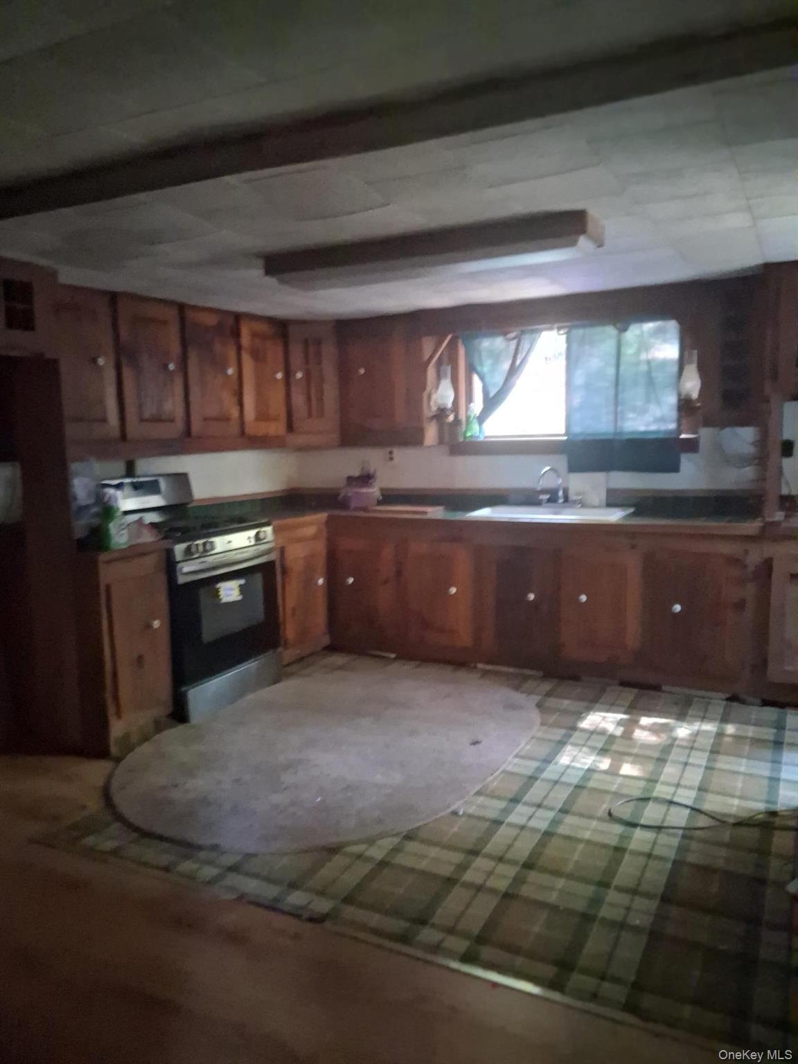 84 N Road Red Hook, NY 12571 - Photo 7 of 22 Kitchen with brown cabinetry and gas stove
