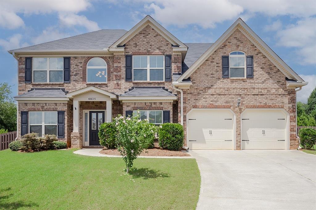6025 Andrew Way Cumming, GA 30041 - Photo 1 of 1 a front view of a house with a yard and garage