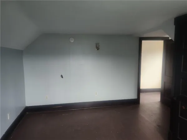 a view of an empty room and wooden floor