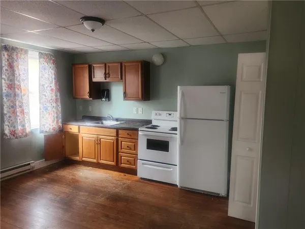 a kitchen with a refrigerator and window