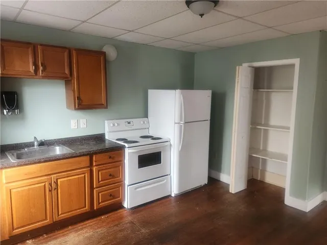 a kitchen with cabinets appliances and a counter space