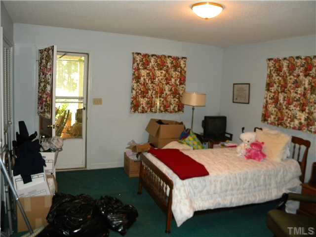 1426 Trinity Circle Raleigh, NC 27607 - Photo 8 of 12 Master bedroom has a seperate door which enters the car port area. The master bedoom has a full bath with stand up shower.