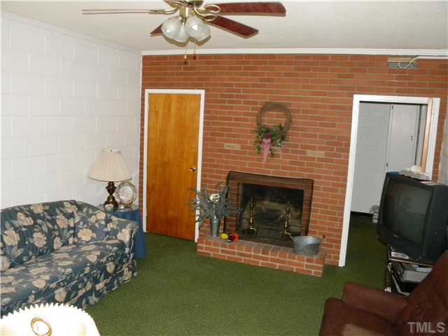 1426 Trinity Circle Raleigh, NC 27607 - Photo 10 of 12 Family Room is located in the basement with a seperate side entrance on lower level of home.