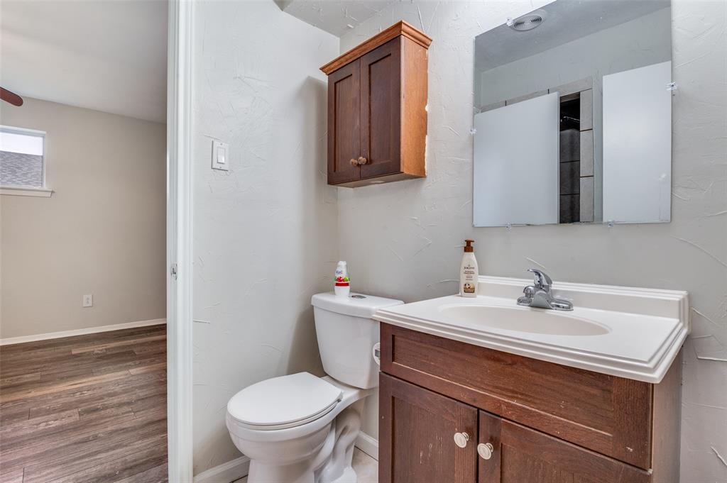 2244 Homeway Circle Dallas, TX 75228 - Photo 12 of 12 Bathroom with vanity, wood finished floors, and a textured wall