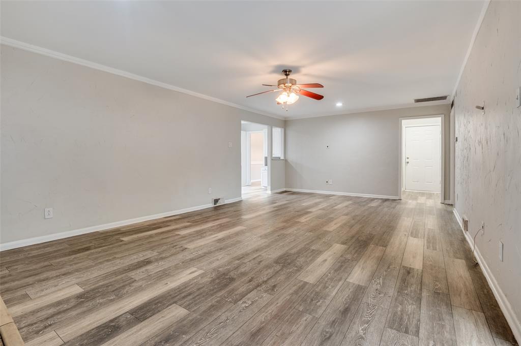 2244 Homeway Circle Dallas, TX 75228 - Photo 6 of 12 Spare room featuring light wood-style flooring, ornamental molding, and ceiling fan