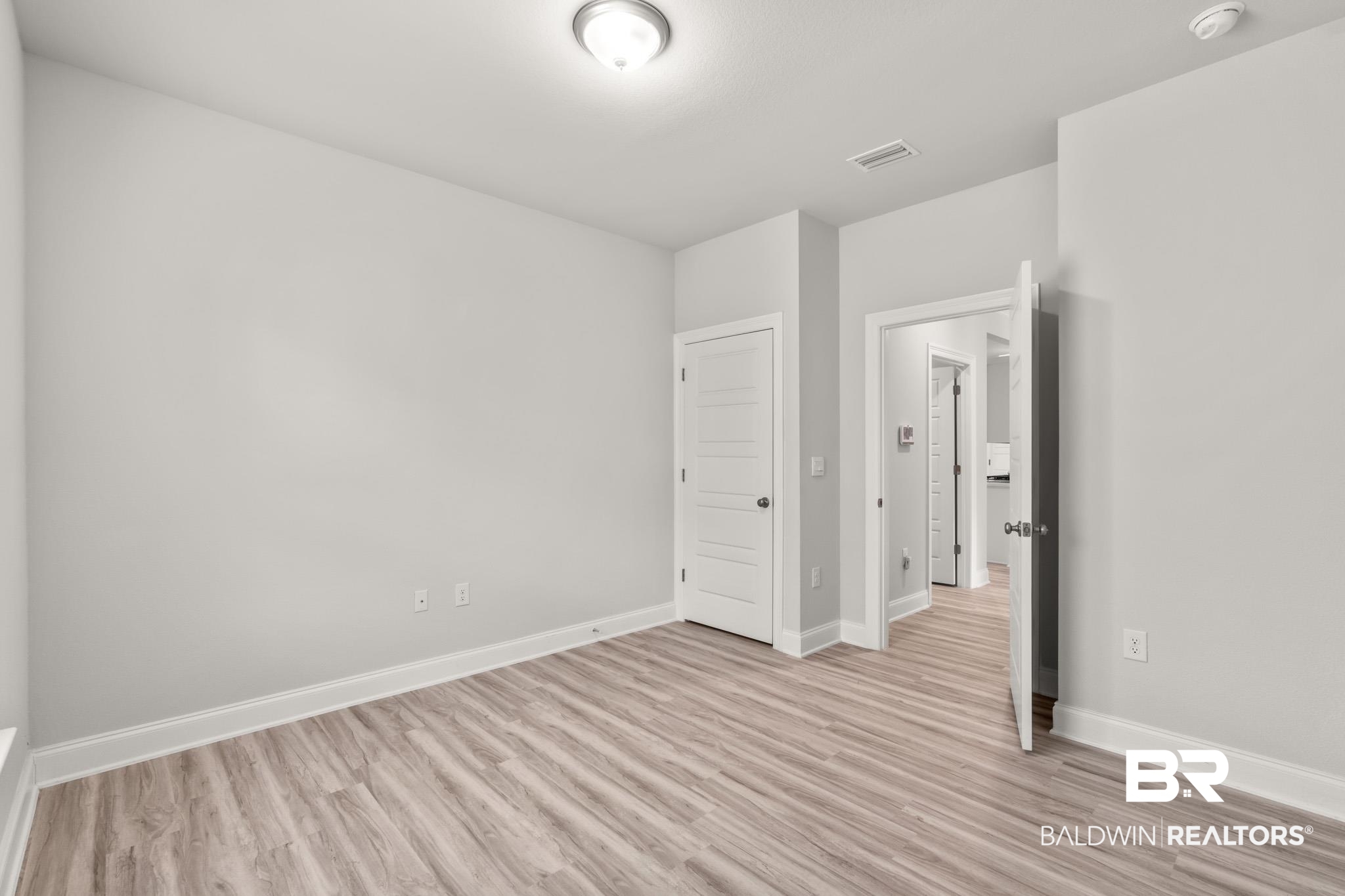 32125 Lyon Road Daphne, AL 36527 - Photo 22 of 70 Spacious room featuring light wood-finish flooring, neutral wall paint, white trim, and recessed lighting