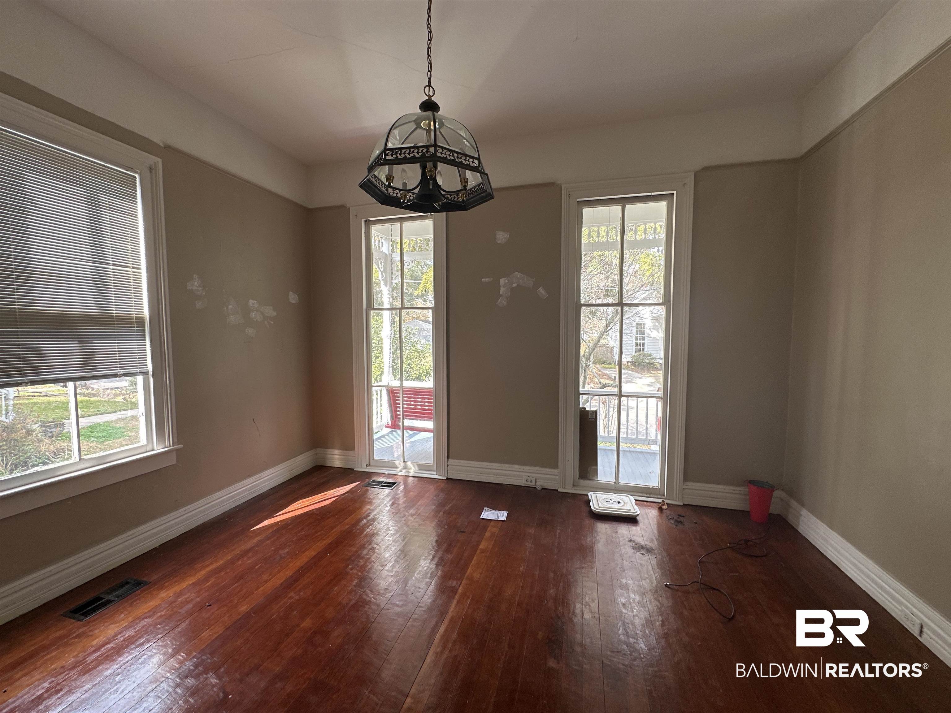 1119 Old Shell Road Mobile, AL 36604 - Photo 7 of 22 Unfurnished dining area with dark wood-type flooring and a healthy amount of sunlight