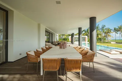 a dining room with furniture and a floor to ceiling window