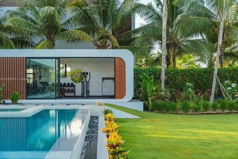 a swimming pool with outdoor seating yard and green space