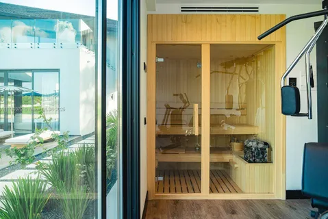 a bathroom with a glass shower door and a mirror
