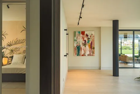 a view of a hallway with paintings on the wall