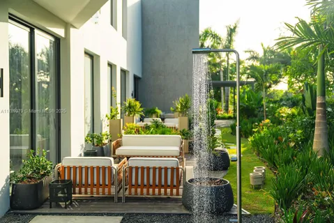 a view of a porch with chairs and potted plants
