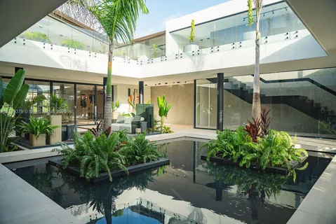 a front view of a house with plants