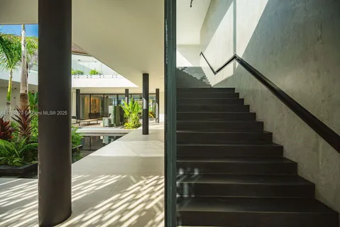 a view of staircase with wooden floor and a rug