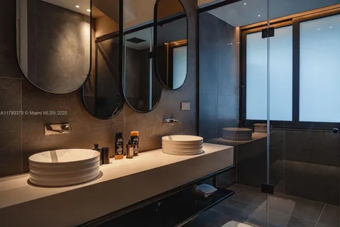a bathroom with a double vanity sink and a mirror