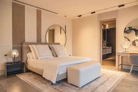 a bedroom with a bed and a table with the outer view