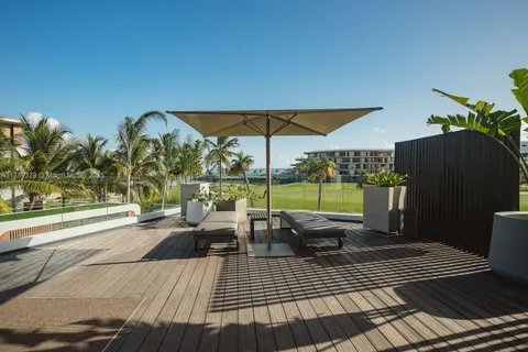 a view of a patio with dining table and chairs under an umbrella