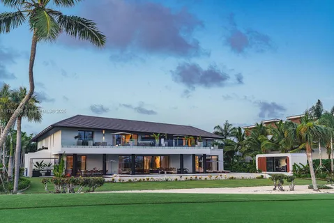 a front view of residential houses with yard and green space