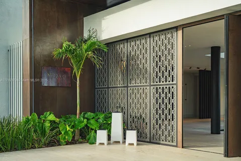 a couple of potted plants in front of door